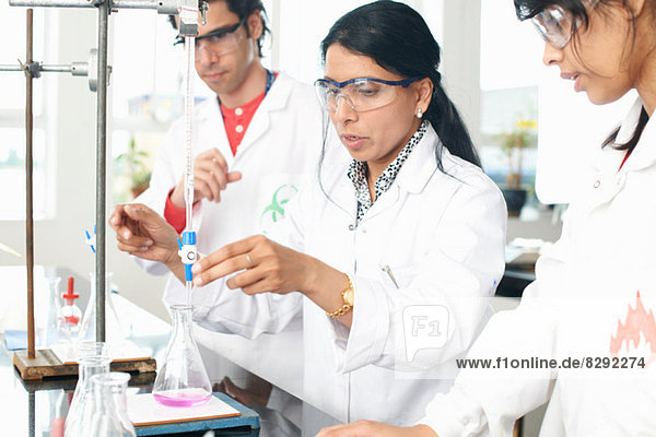 Chemistry teacher doing experiment with students