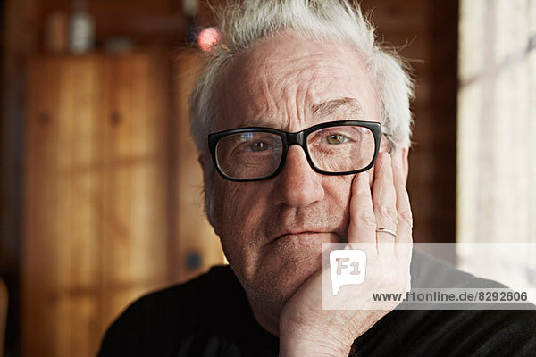 Senior man with grey hair and glasses