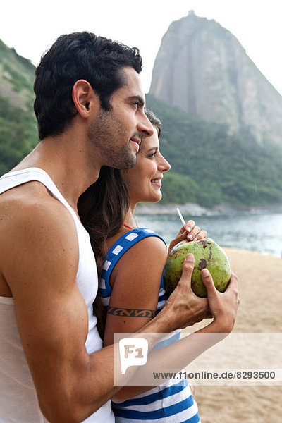 Portrait of couple on beach with Sugarloaf Mountain  Rio de Janeiro  Brazil