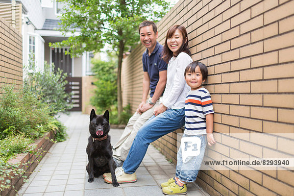 Family outdoors with pet dog