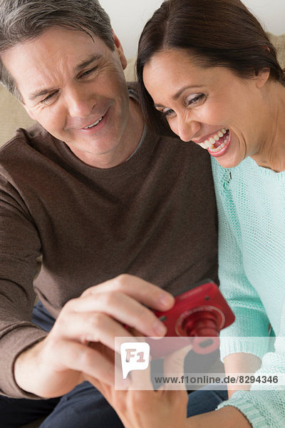 Mature couple looking at digital camera