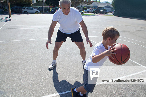 Man and grandson playing basketball