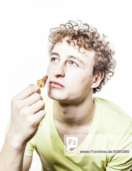 Young man eating chocolate