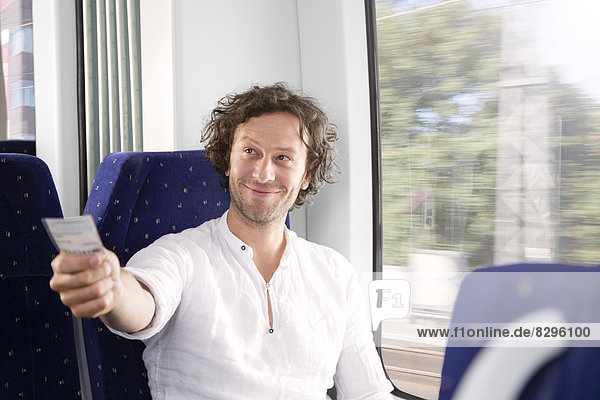 Man showing ticket in a train