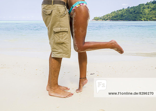 Thailand  Koh Surin island  couple kissing at white sandy beach