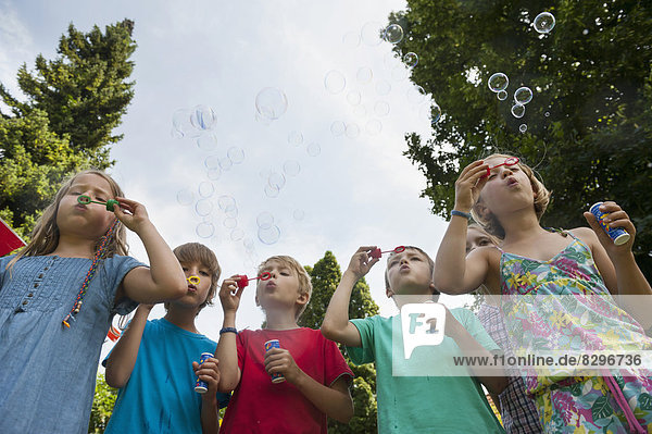 Children blowing soap bubbles