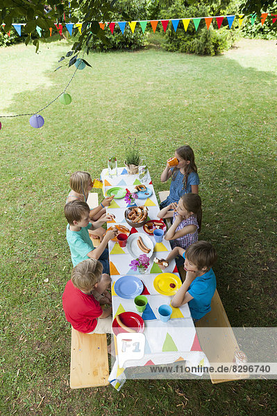 Children sitting at table on a birthday party