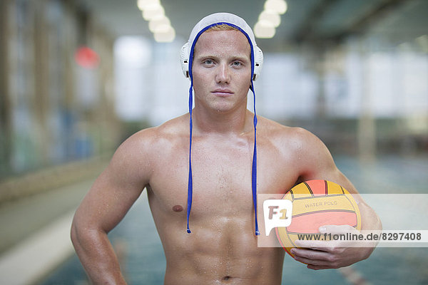 Water polo player outside pool holding ball