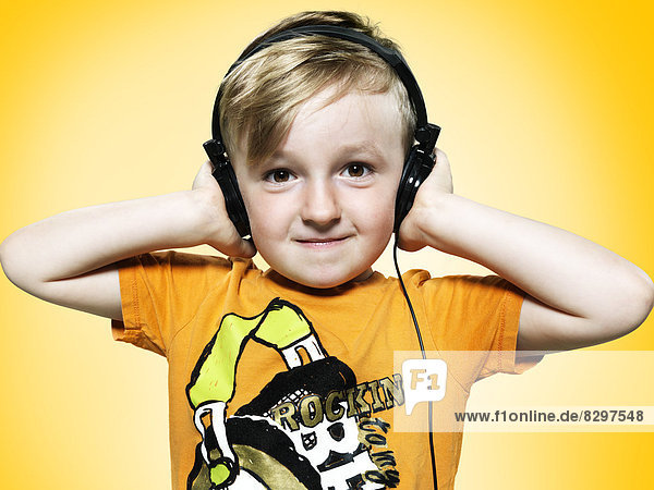 Portrait of little boy with headphones  studio shot