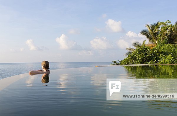 Woman in an infinity pool looking out to sea  Koh Samui  Thailand  Southeast Asia  Asia