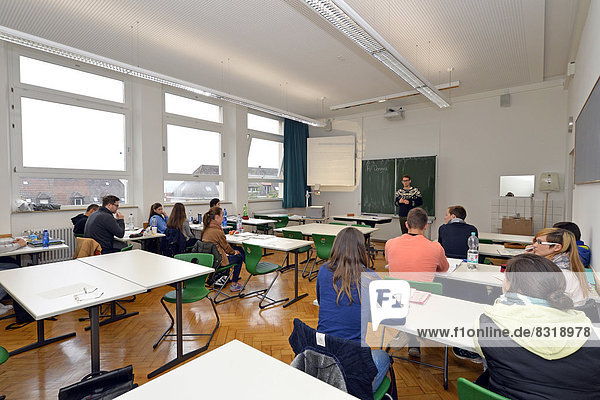 Young trainee teacher teaching a class classroom