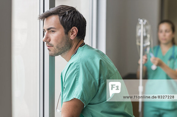 Doctor looking out window