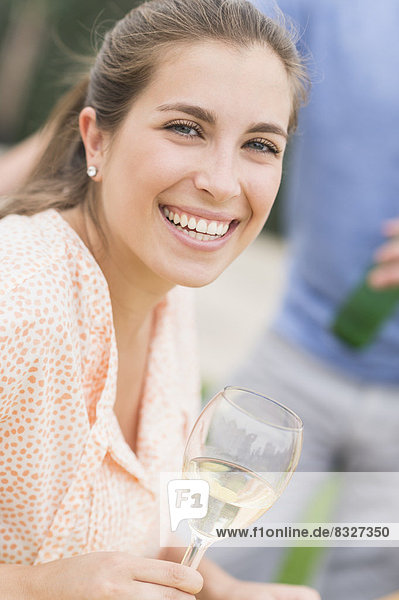 Portrait of woman drinking white wine