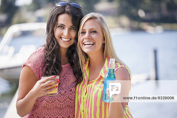 Portrait of young women posing with drinks