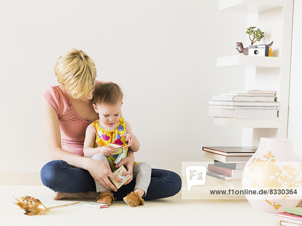 Mother playing with baby daughter (12-17 months)