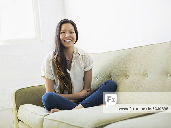 Portrait of woman sitting on sofa