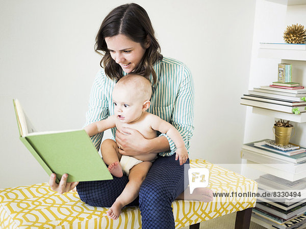 Mother with son (6-11 months) reading book