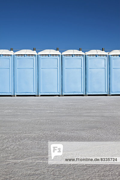 Row of portable toilets on Bonneville Salt Flats  during Speed Week