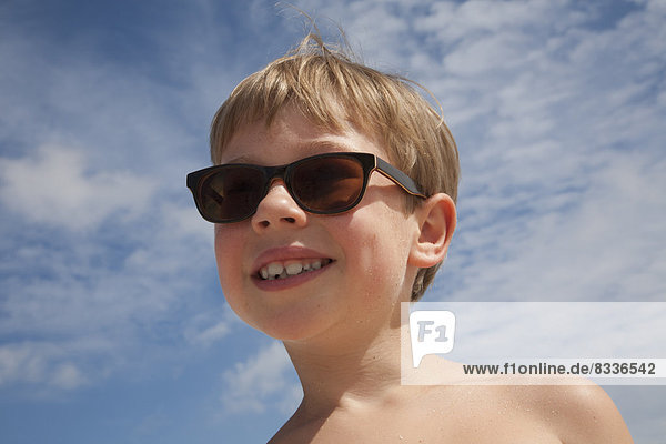 A young boy wearing sunglasses.