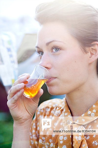 Woman drinking at garden party