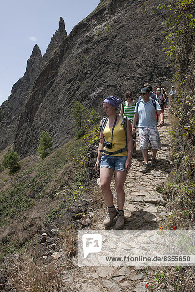 Hikers on a trail on the steep slopes of the Paúl Valley  Santo Antão island  Cape Verde
