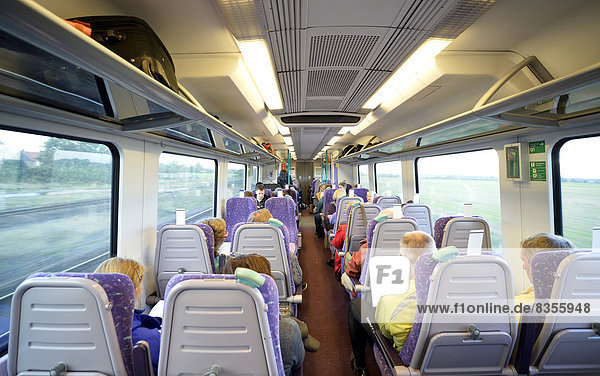 Interior of an open-plan carriage with travellers in the Pennine Express of the East Coast Railway  England  United Kingdom