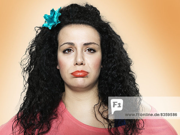 Portrait of young woman pouting  studio shot