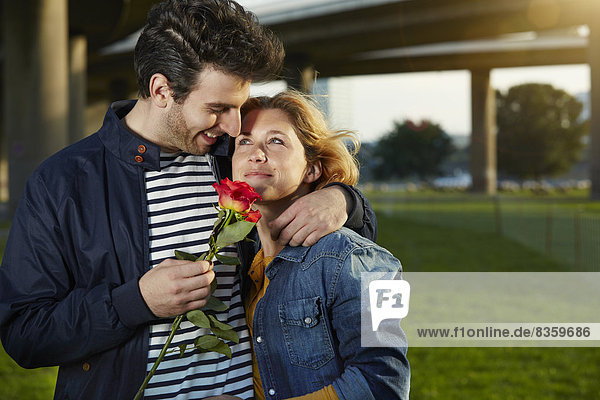 Germany  Dusseldorf  Young couple with red rose
