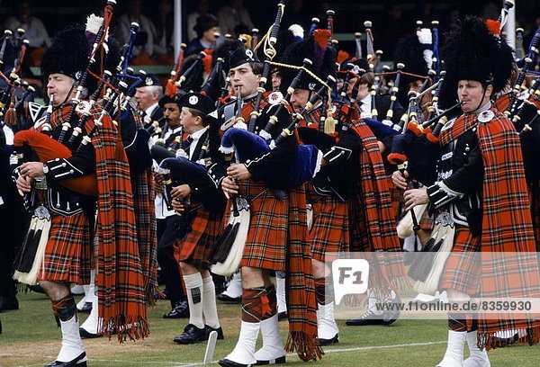 Traditional Scottish band in tartan kilts marching at the Braemar Royal Highland Gathering  the Braemar Games in Scotland
