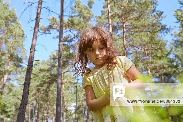 Girl with hands clasped in forest