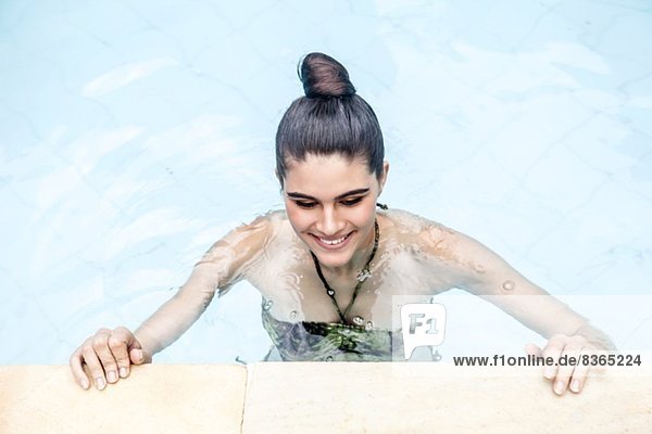 Overhead view of young woman in swimming pool