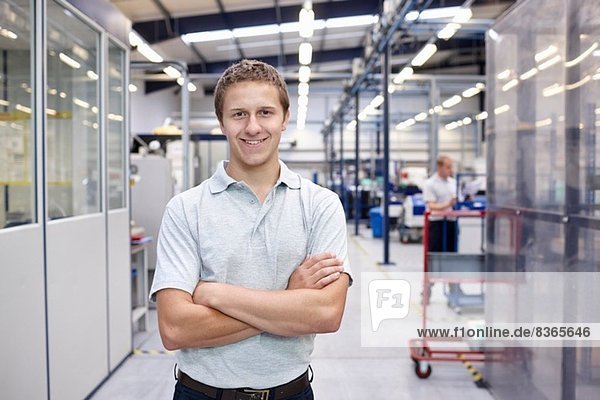 Portrait of worker with arms folded in engineering factory