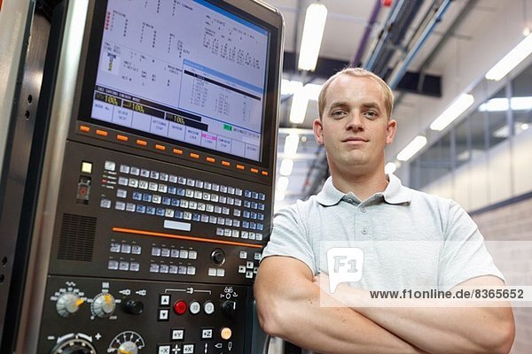 Portrait of engineer and control panel in engineering factory