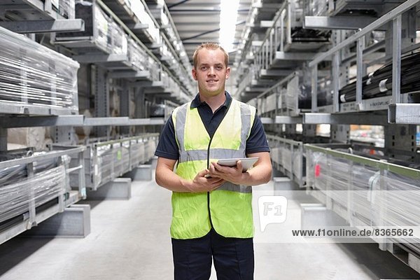 Portrait of worker in engineering warehouse