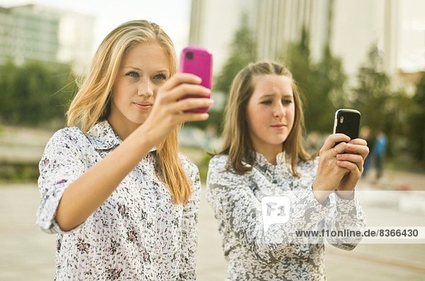 Zwei junge Frauen beim Selbstporträt auf dem Handy