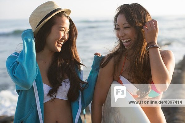 Two female friends with surfboard  San Diego  California  USA