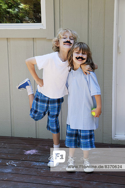 Brother And Sister Posing With Pretend Moustaches Pacifica  California  United States Of America