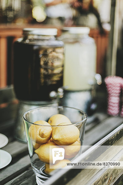 A Glass Bowl Filled With Small Lemons Beside Beverage Containers Pemberton  British Columbia  Canada