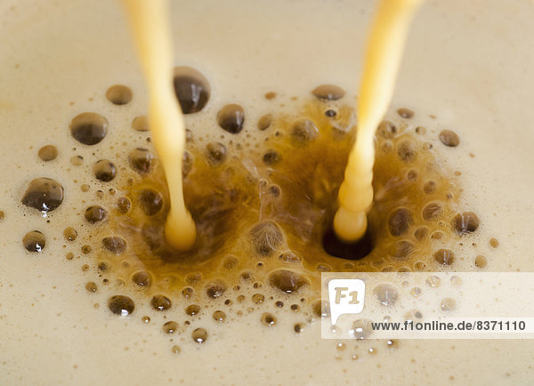 Two Streams Of Milk Being Poured Into Frothy Coffee Locarno  Ticino  Switzerland