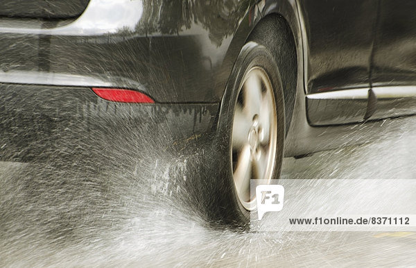 A Car Tire Splashing Through Water Locarno  Ticino  Switzerland