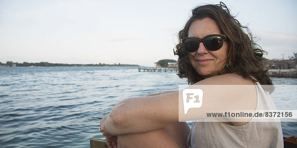 Portrait Of A Woman Sitting On The Water's Edge Utila  Bay Islands  Honduras