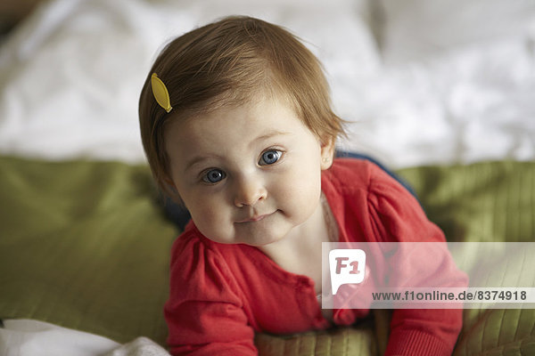 A Baby Girl Poses For A Portrait While Lying On A Bed Ottawa  Ontario  Canada