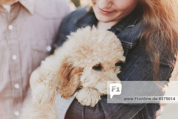 A Woman Holds Her Pet Dog In Her Arms Crescent Beach  British Columbia  Canada