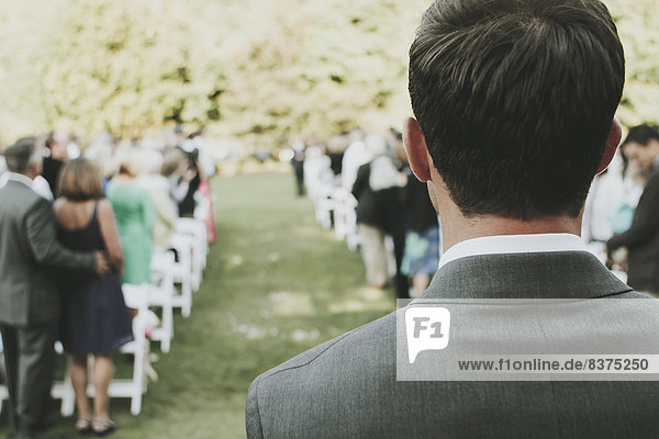 A Man Standing At The Top Of The Aisle At An Outdoor Wedding Kirkland  Washington  United States Of America