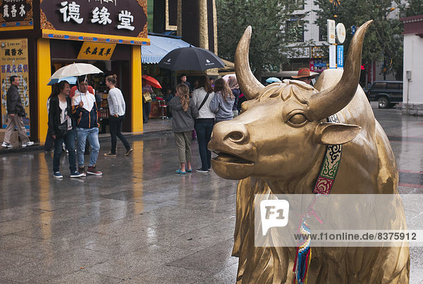 A Golden Ox Statue On A Rainy Day  Tibet  China