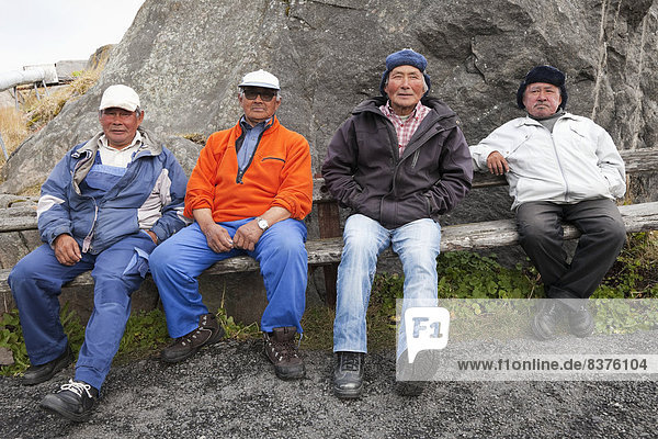 Four Inuit Men Sitting On A Bench In A Village  Kangaamiut  Greenland