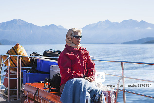A Traveler Enjoying A Scenic Boat Cruise On Lake Manapouri To Doubtful Sound  New Zealand