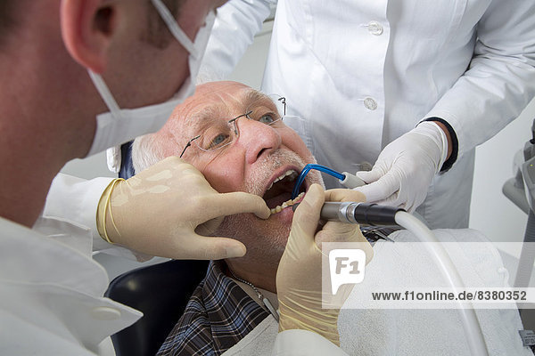 Senior man receiving treatment at the dentist  Germany