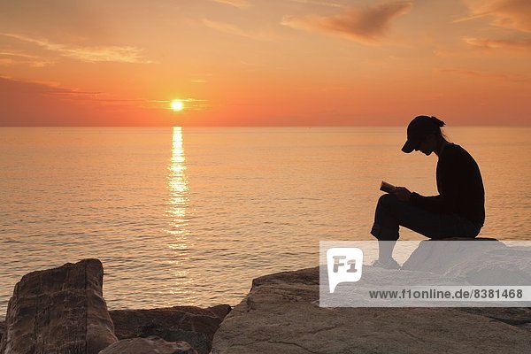 sitzend Frankreich Europa Frau Sonnenuntergang Küste Korsika vorlesen
