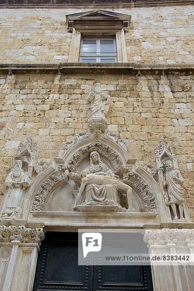 Statue of Our Lady of Sorrow and St. John the Baptist on the portal of the Franciscan church  Dubrovnik. Croatia  Europe